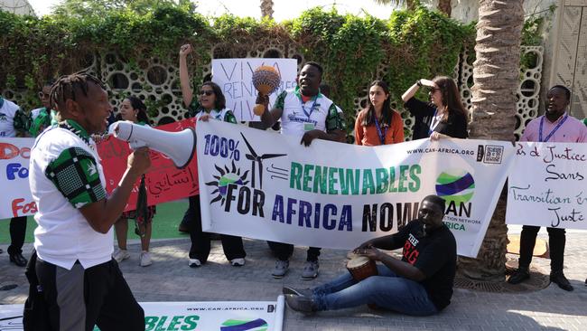 Activists demand investment into renewable energies infrastructure in Africa during a small protest on day six of COP28.