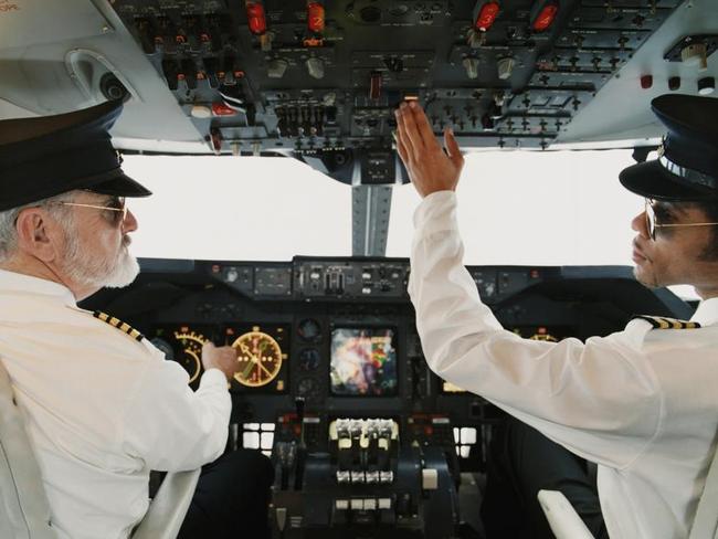 Portrait of Pilots Sitting in the Cockpit, Adjusting the Controls