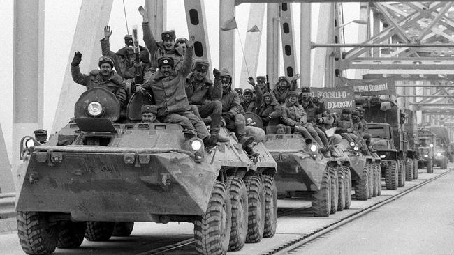 Soviet army soldiers waving as their last detachment crosses the bridge on the border between Afghanistan &amp; then-Soviet Uzbekistan, near the Uzbek town of Termez, on 15 February 1989. Picture: AP