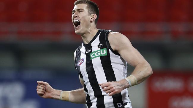 Mason Cox of the Magpies celebrates a goal.