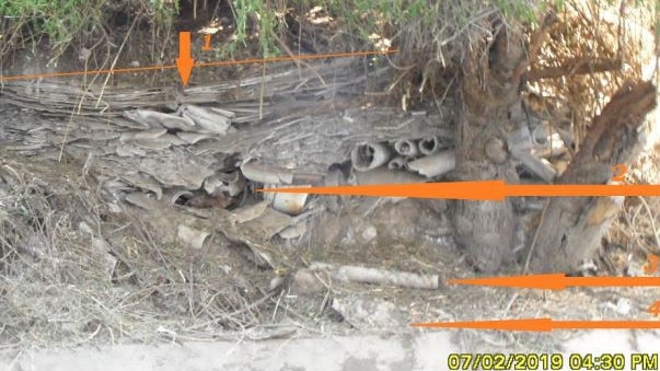 Asbestos pieces and contaminated dirt/dust spilling down the A'Becketts canal in Granville.