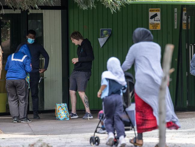 Children walk past intoxicated people outside the Richmond injecting room.