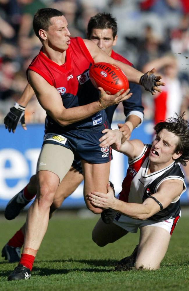 Nathan Brown with the ball as St Kilda’s Stephen Milne tackles in 2003.