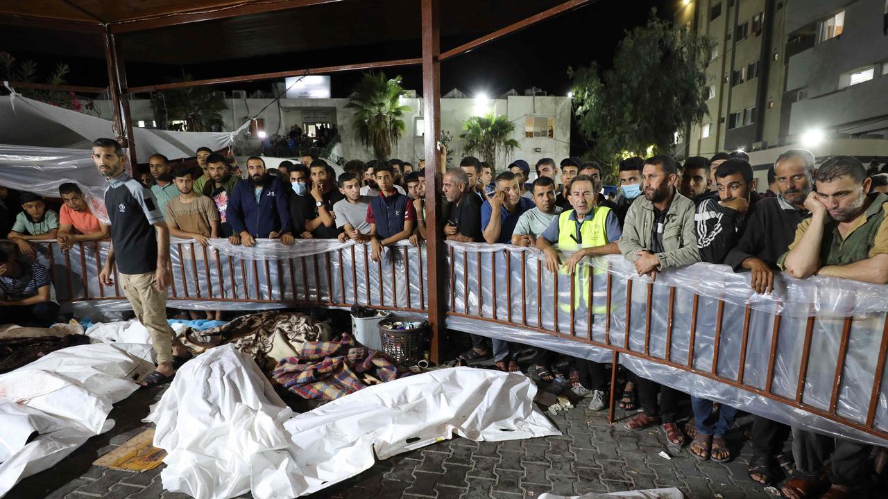 People gather around bodies of Palestinians killed after a blast ripped through the Ahli Arab hospital in central Gaza. Israel and Palestinians have traded blame for the incident. Picture: Dawood N<i>EMER</i> / AFP