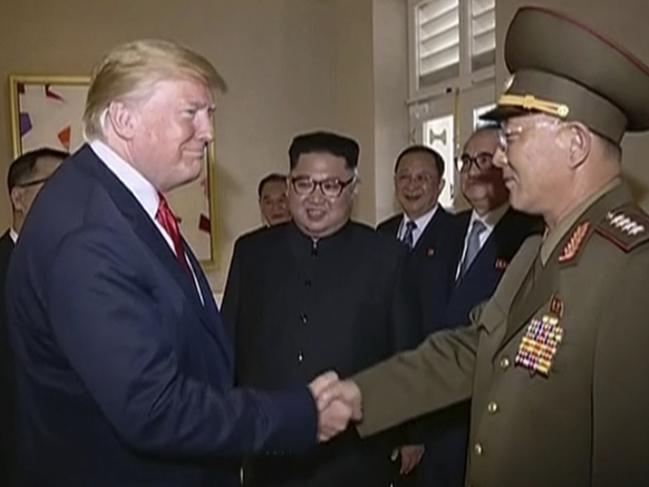In this image made from June 12, 2018, video released by KRT, U.S. President Donald Trump shakes hands with No Kwang Chol, minister of People's Armed Forces of North Korea, as North Korean leader Kim Jong Un, center, introduces Trump to the general during the summit in Singapore. (KRT via AP Video)