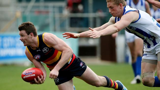 Patrick Dangerfield gets a handpass away as Jack Ziebell looks on. Picture: Colleen Petch.