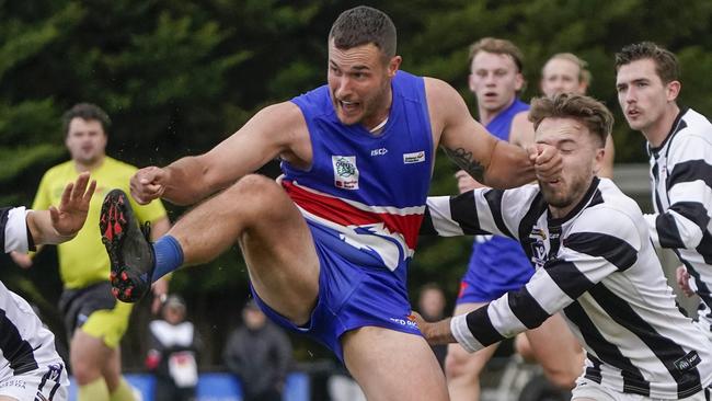 Clinton Johnson tries to kick the ball for Wandin. Picture: Valeriu Campan