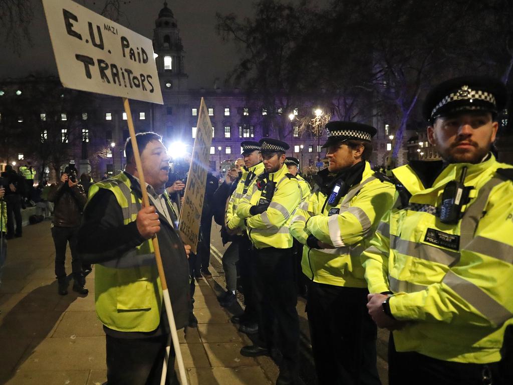 An pro-Brexit demonstrator confronts police officers in Parliament Square in London. Picture: AP