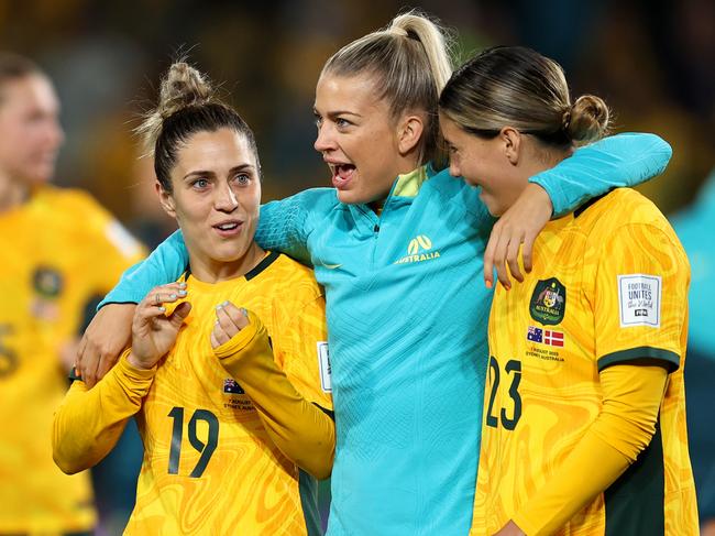 SYDNEY, AUSTRALIA - AUGUST 07: (L-R) Katrina Gorry, Charlotte Grant and Kyra Cooney-Cross of Australia celebrate the teamÃ¢â¬â¢s 2-0 victory and advance to the quarter final following the FIFA Women's World Cup Australia & New Zealand 2023 Round of 16 match between Australia and Denmark at Stadium Australia on August 07, 2023 in Sydney / Gadigal, Australia. (Photo by Brendon Thorne/Getty Images )