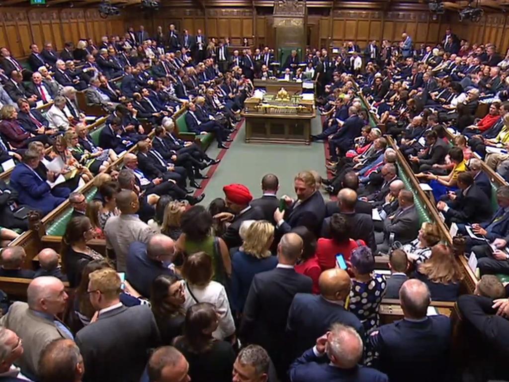 Crowds of MPs squeezed to get into Britain’s House of Commons.