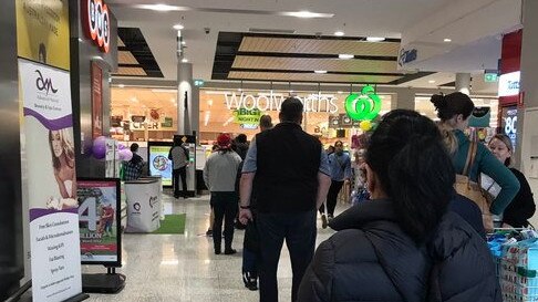 Shoppers queue at Woolworths in Melbourne. Picture: Leo Stubbing on Twitter.