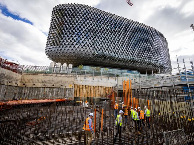 Experts visit the Australian Bragg Centre construction site, and walk on the roof of the bunker that will house the proton therapy unit. Picture James Elsby