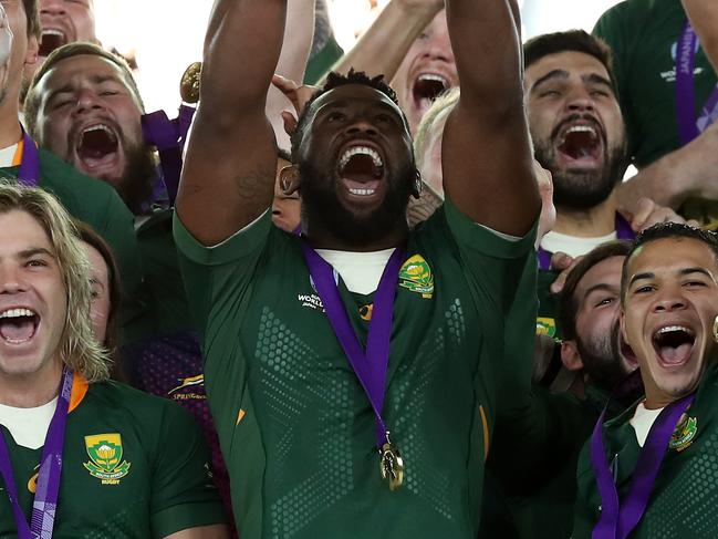 YOKOHAMA, JAPAN - NOVEMBER 02:  Siya Kolisi, the South Africa captain, celebrates with team mates after their victory during the Rugby World Cup 2019 Final between England and South Africa at International Stadium Yokohama on November 02, 2019 in Yokohama, Kanagawa, Japan. (Photo by David Rogers/Getty Images)