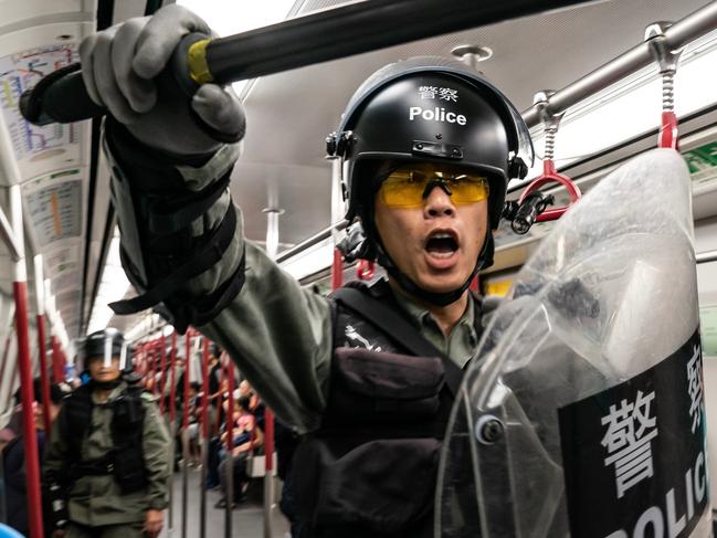 HONG KONG, CHINA - SEPTEMBER 1: Riot police charge in a train at the Tung Chung MTR station after protesters block the transport routes to the Hong Kong International Airport on September 1, 2019 in Hong Kong, China. Pro-democracy protesters have continued rallies on the streets of Hong Kong against a controversial extradition bill since 9 June as the city plunged into crisis after waves of demonstrations and several violent clashes. Hong Kong's Chief Executive Carrie Lam apologized for introducing the bill and declared it "dead", however protesters have continued to draw large crowds with demands for Lam's resignation and completely withdraw the bill. (Photo by Anthony Kwan/Getty Images) BESTPIX