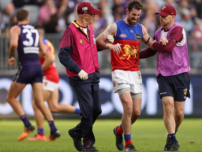 Darcy Gardiner is assisted from the field after hurting his ribs against Fremantle. Picture: Paul Kane / Getty Images