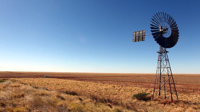 water windmill bore in generic views of outback desert features , 100km west of Mt Isa , QLD.