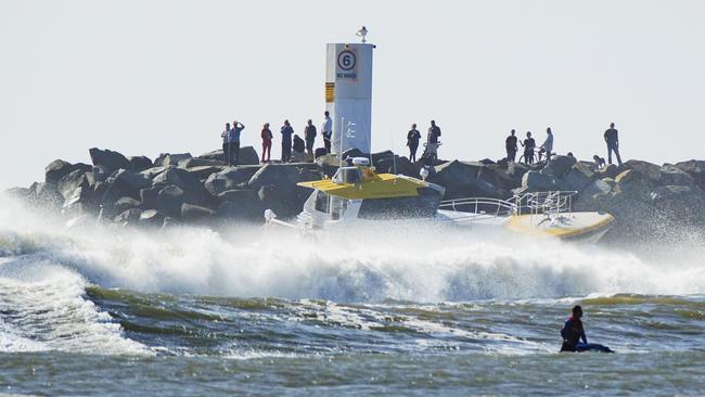 A boat crossing the Mooloolaba Bar in rough seas. Picture Lachie Millard