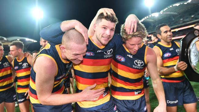 Bryce Gibbs of the Crows is carried off the field by Sam Jacobs (left) and Rory Sloane after his 250th AFL game in the Showdown. Picture: AAP Image/David Mariuz