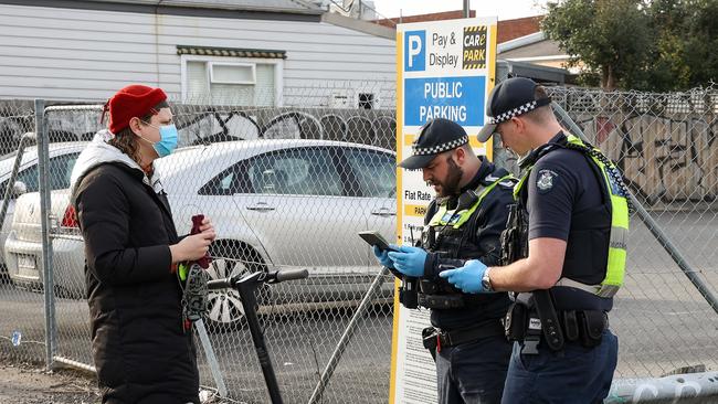 Police pull over a woman riding a privately owned E-Scooter in Brunswick. Picture NCA NewsWire / Ian Currie