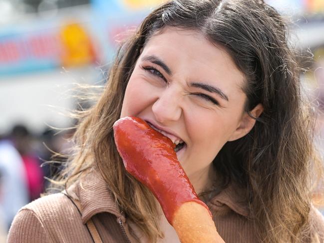 SEPTEMBER 5, 2022: Sophie Penberthy, with a $16 foot long wonder dog, takes part in a show food review at the Royal Show. Picture: Brenton Edwards