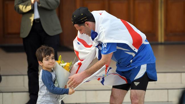 Victorian runner Isak Ketsakitis arrives at St Hurmizd's Cathedral (Assyrian Church of the East, Greenfield Park, on Sunday. Picture: Simon Bullard