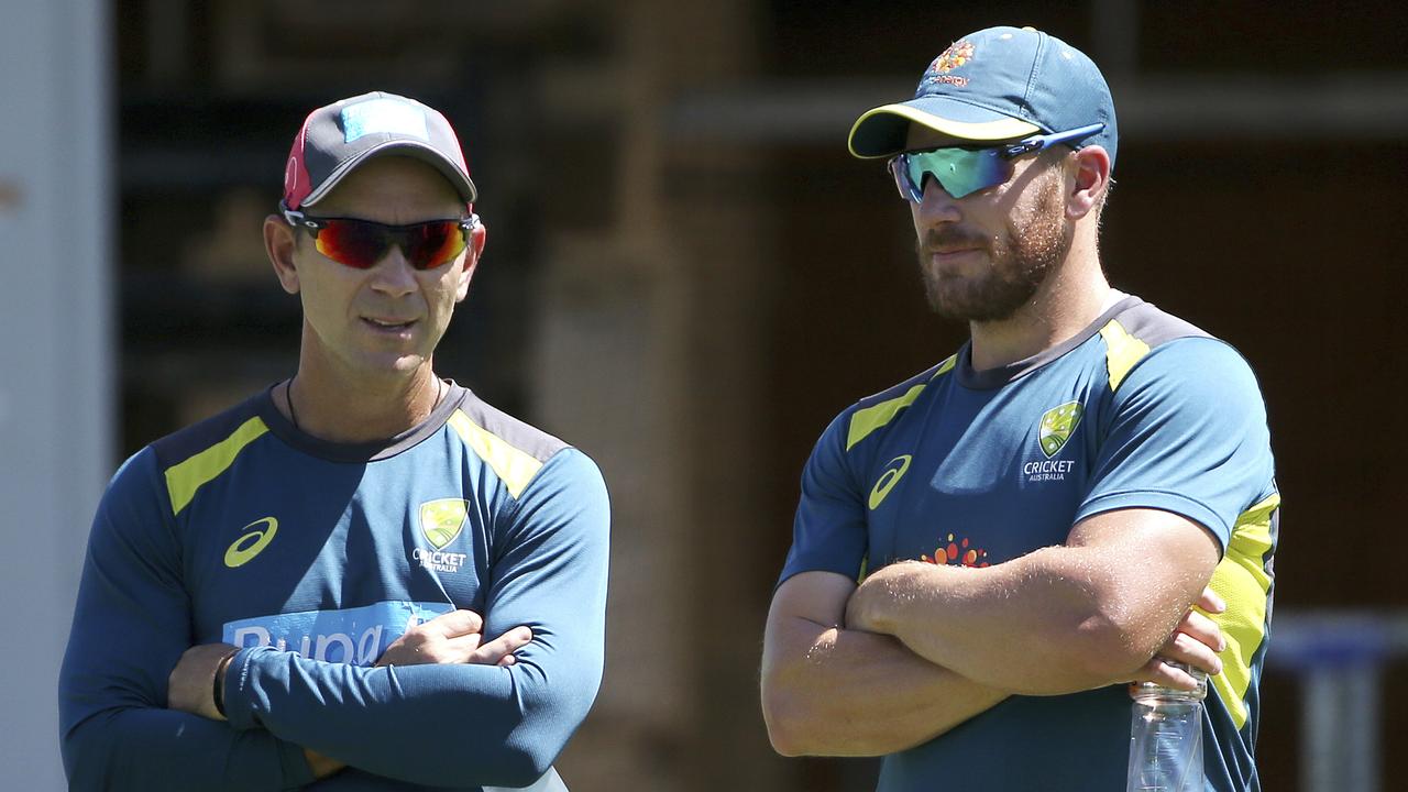 Aaron Finch chats with Justin Langer. Photo: Rick Rycroft/AP Photo. 