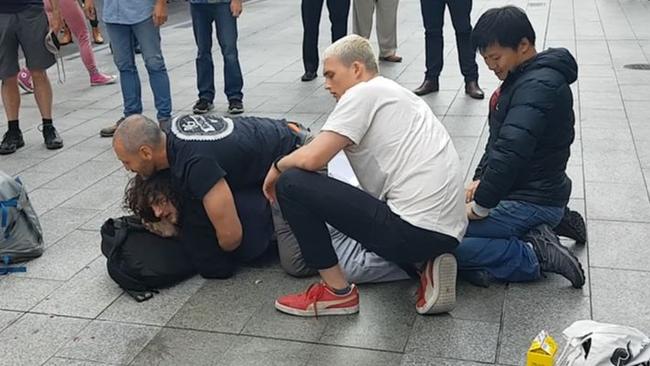 Barry Phillip Siecker is pinned down in Rundle Mall. Picture: Shaun Hollis