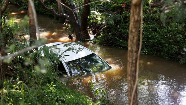 A 44-year-old woman is dead after her car was swept away in floodwaters in Aspley last night. Pics Tara Croser.