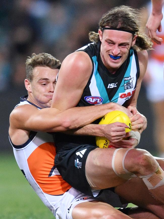 Giant Zac Langdon tackles Jarrod Lienert in his first game for the Power. Picture: AAP Image/David Mariuz