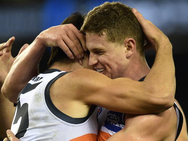 Matthew Kennedy (left) and Jacob Hopper of the Giants react after Kennedy kicked a goal during the Round 13 AFL match between the Essendon Bombers and the GWS Giants at Etihad Stadium in Melbourne, Sunday, June 19, 2016. (AAP Image/Julian Smith) NO ARCHIVING, EDITORIAL USE ONLY