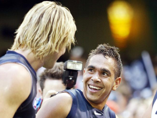 Wizard Cup: Essendon v Carlton, Telstra Dome. A smiling Eddie Betts walks off the ground with David Teague.