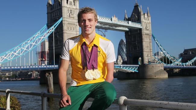 Australian Paralympic Games swimmer Matthew Cowdrey poses with his eight medals at Tower Bridge in London in 2012. Picture: Ian MacNicol