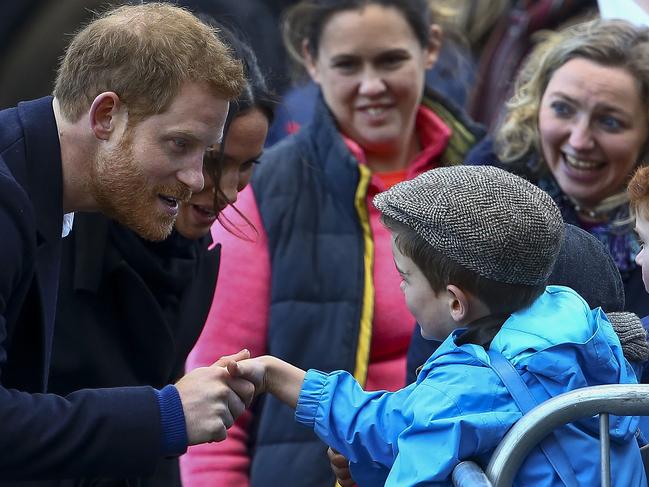 Britain’s Prince Harry and his fiancée Meghan Markle greet well-wishers on their arrival to Cardiff Castle in Cardiff, south Wales on January 18, 2018, for a day showcasing the rich culture and heritage of Wales. Picture: AFP