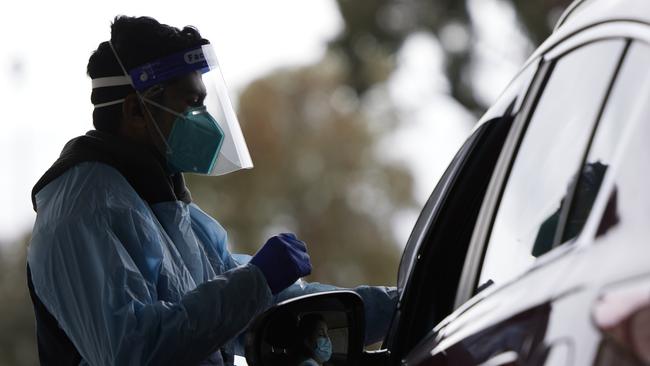 Medical staff conduct COVID-19 tests at the Merrylands drive-through clinic. Picture: Brook Mitchell/Getty Images