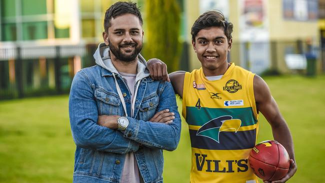 Port Adelaide premiership player Peter Burgoyne (left), with his eldest son, Eagles under-18 player Trent, at Woodville Oval. Picture: AAP/Roy Van Der Vegt.