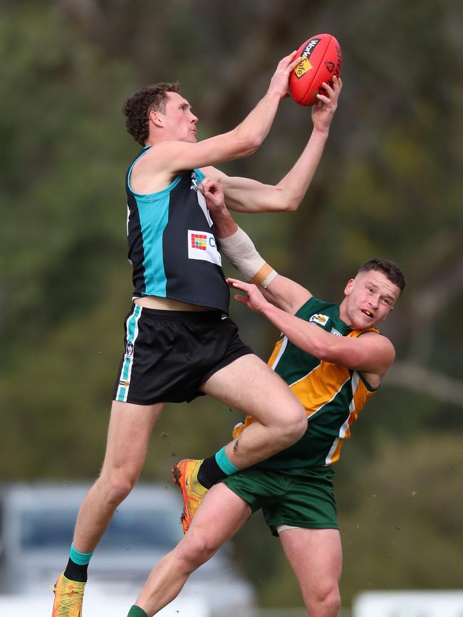 Dookie United’s Tom Johnstone launches over the top of Murchison-Toolamba’s Jayedo Hexter.