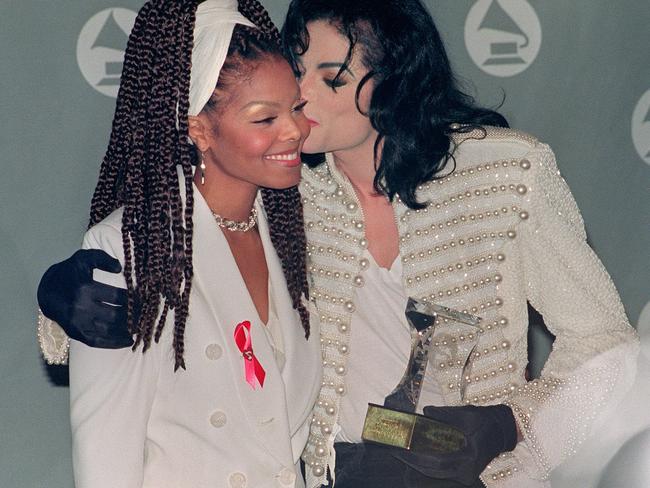 Michael Jackson kisses his sister Janet Jackson (L) after she presented him with the Grammy Legend Award at the 35th Annual Grammy Awards February 24,1993. Picture: AFP