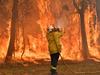 TOPSHOT - A firefighter conducts back-burning measures to secure residential areas from encroaching bushfires in the Central Coast, some 90-110 kilometres north of Sydney on December 10, 2019. - Toxic haze blanketed Sydney on December 10 triggering a chorus of smoke alarms to ring across the city, as Australians braced for "severe" weather conditions expected to fuel deadly bush blazes. (Photo by Saeed KHAN / AFP)