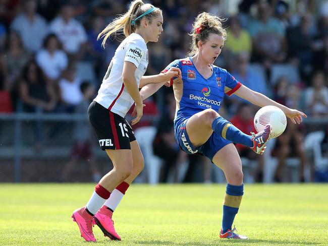 Ellie Carpenter (left) battles for posession with Newcastle’s Rhali Dobson during the Wanderers round 4 win against the Jets. Picture: Tony Feder/Getty Images