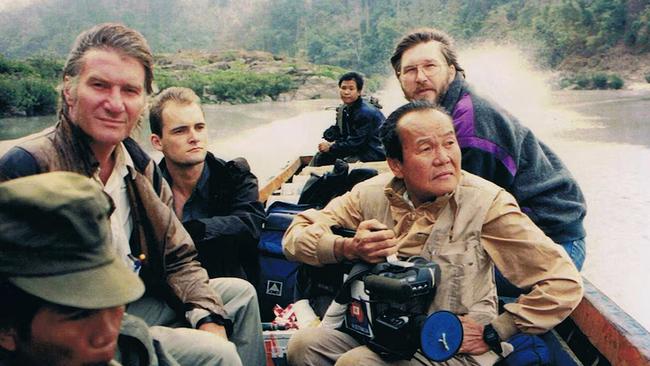 Phua travelling by boat from Thailand to Myanmar in 1992 with Australian correspondents. Picture: National Museum of Singapore