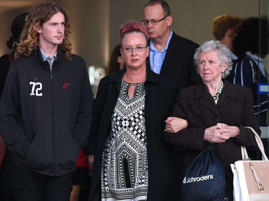 Manslaughter victim Darren Pullar’s partner Collette Dunn (centre) and his son Aidan (left) leave the Supreme Court in Brisbane today. Picture: AAP Image/Dan Peled