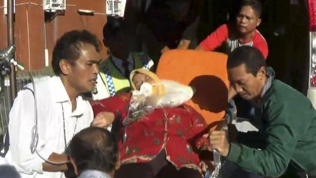 An injured passenger is taken to hospital after the flight landed at Soekarno-Hatta International Airport. Picture: AP Photo/APTN