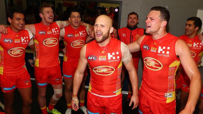 Steven May and Gary Ablett sing the Suns song with their teammates after a win in their milestone game. Picture: Getty