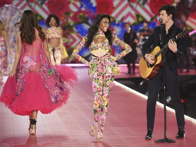 Winnie Harlow, center, walks the runway as Shawn Mendes, right, performs during the 2018 Victoria's Secret Fashion Show at Pier 94 on Thursday, Nov. 8, 2018, in New York. (Photo by Evan Agostini/Invision/AP)