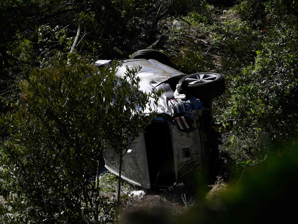 The vehicle driven by golfer Tiger Woods lies on its side in Rancho Palos Verdes, California, on February 23, 2021. (Photo by Patrick T. FALLON / AFP)