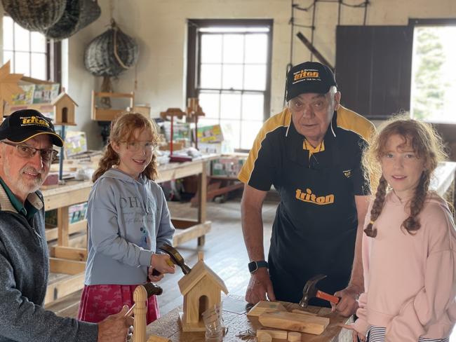 Abigail and Caitlin working in the Triton Woodworkers workshop with Louis and Geoff at Flagstaff Hill Warrnambool