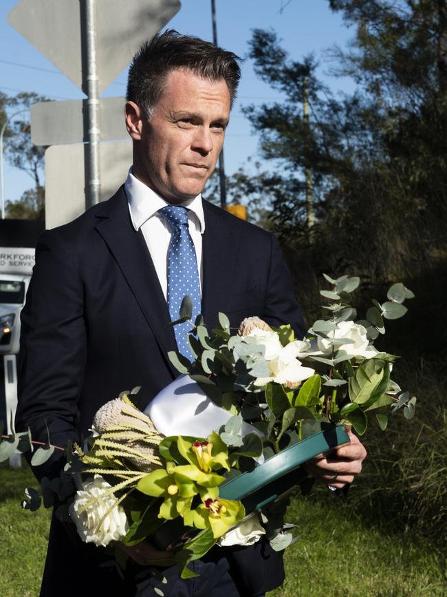 NSW Premier Chris Minns laying a wreath at the public memorial of the Greta bus crash last year. Picture: Rhett Wyman