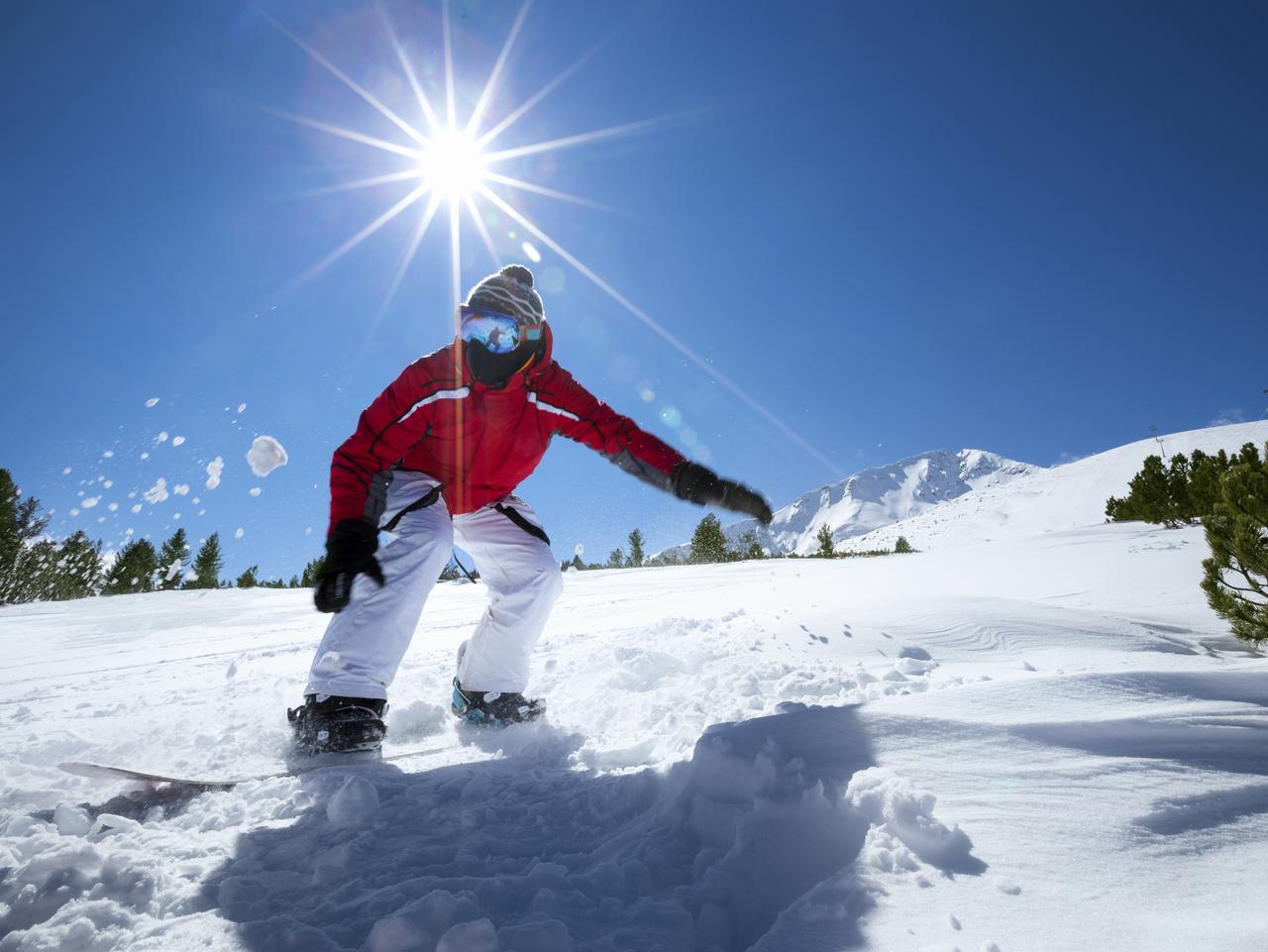 Man holding Snowboard Side