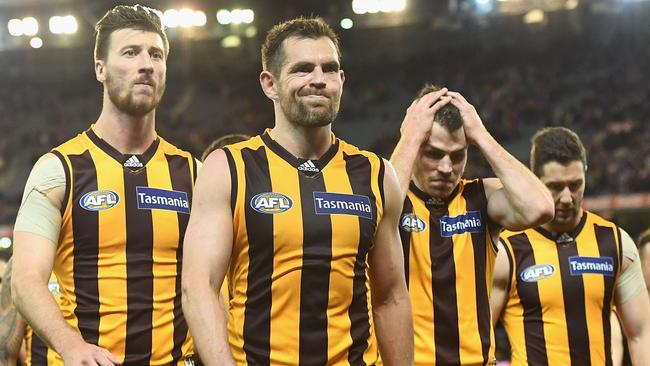 Jack Fitzpatrick, Luke Hodge and Isaac Smith walk off after Hawthorn’s semi-final loss last season. (Photo by Quinn Rooney/Getty Images)