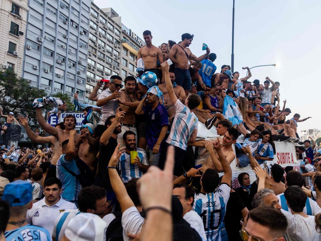 Fans of Argentina celebrate winning the Qatar 2022 World Cup against France at the Obelisk in Buenos Aires